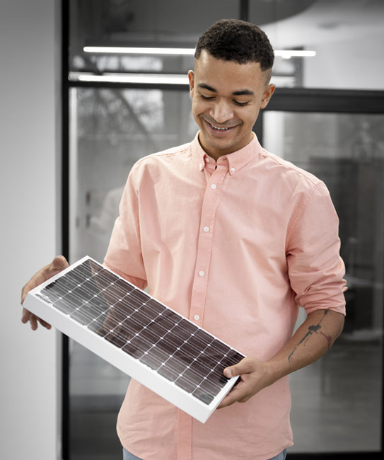 A man holding a solar panel, representing solar energy services.